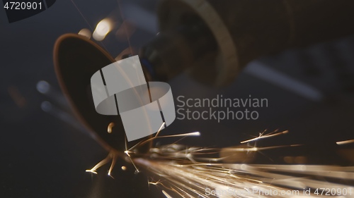 Image of Steel cutter with sparks while cutting steel bar