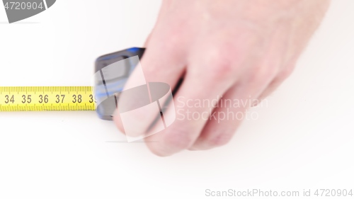 Image of Extending measuring tape on white background