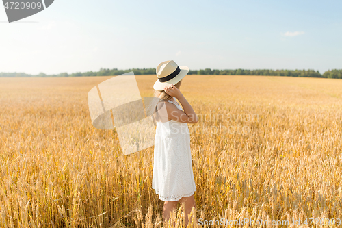 Image of portrait of girl in straw hat on field in summer