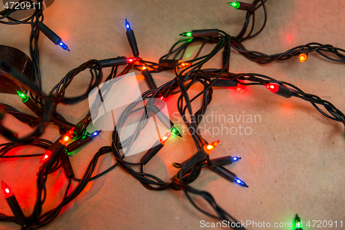 Image of christmas garland lights on wooden background