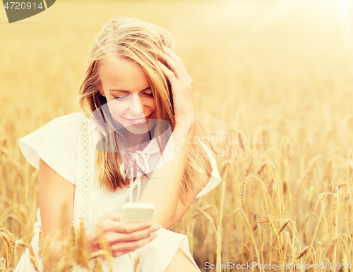 Image of happy woman with smartphone and earphones