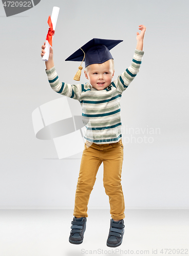 Image of smiling little boy in mortar board with diploma