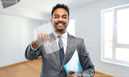 Image of indian man realtor with home keys and folder