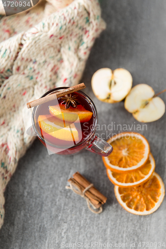 Image of glass of hot mulled wine with orange and cinnamon