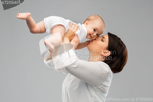 Image of happy mother kissing little baby daughter