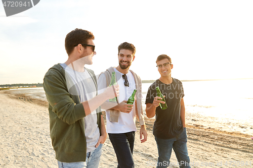 Image of young men toasting non alcoholic beer on beach