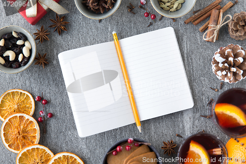 Image of notebook, pencil and hot mulled wine on christmas