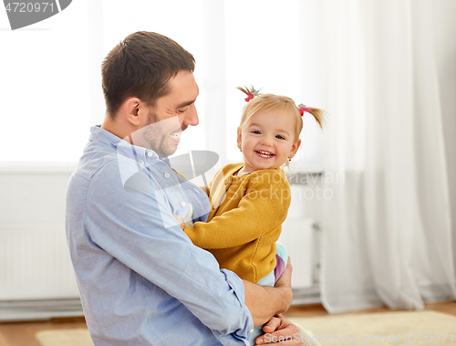 Image of father with little baby daughter at home