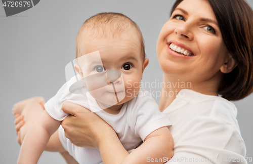 Image of happy middle-aged mother with little baby daughter