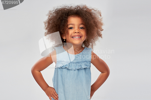 Image of happy little african american girl over grey