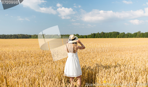 Image of portrait of girl in straw hat on field in summer