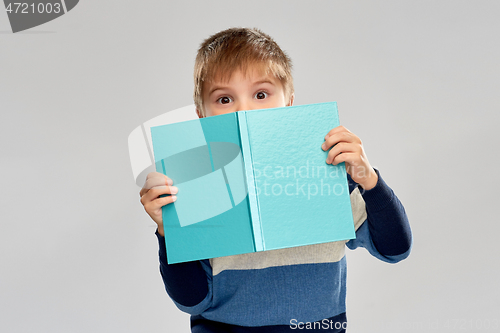 Image of little boy hiding over book