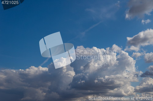 Image of Fluffy clouds in blue sky