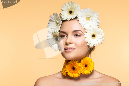 Image of beautiful girl with white and yellow flowers