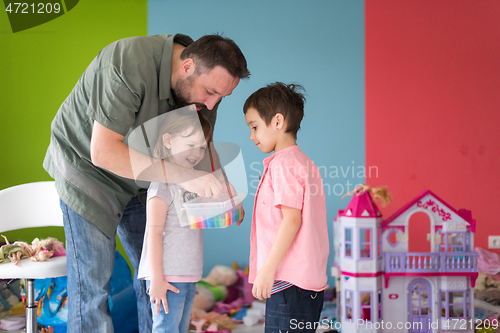 Image of sister and brother havin fun and play hairstylist game at home