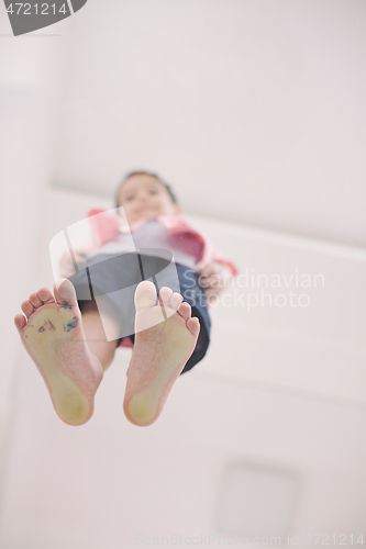 Image of little boy standing on transparent glass floor