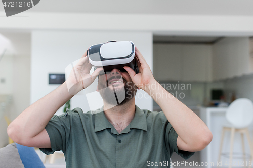 Image of man with beard trying vr glasses