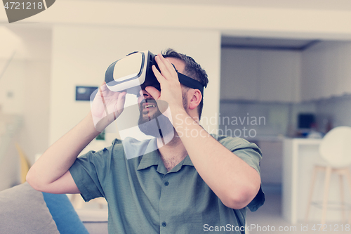 Image of man with beard trying vr glasses