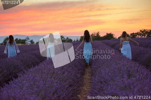 Image of group of famales have fun in lavender flower field