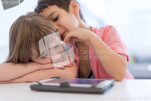 Image of cute little brother and sister having fun at home