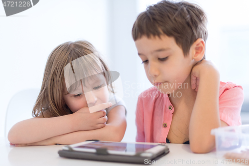 Image of cute little brother and sister having fun at home