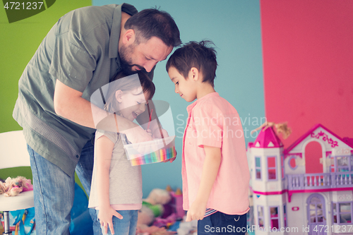 Image of sister and brother havin fun and play hairstylist game at home