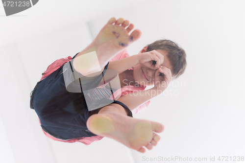 Image of little boy standing on transparent glass floor