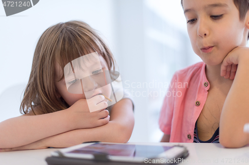 Image of cute little brother and sister having fun at home