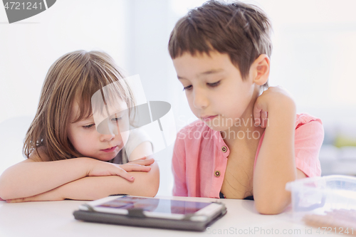 Image of cute little brother and sister having fun at home