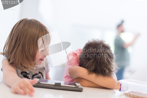 Image of cute little brother and sister having fun at home