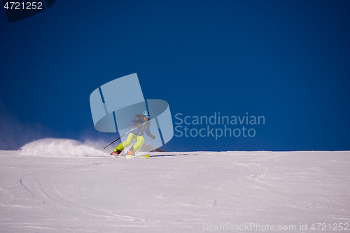 Image of Skier having fun while running downhill