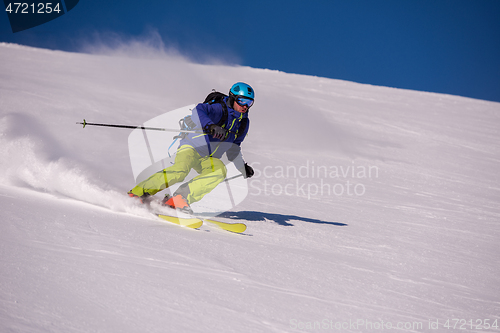 Image of Skier having fun while running downhill