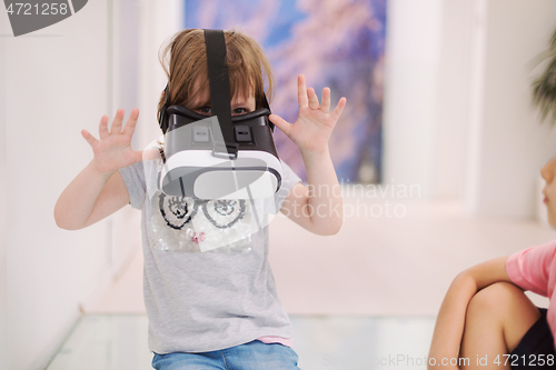 Image of little girl at home wearing vr glasses