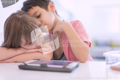 Image of cute little brother and sister having fun at home