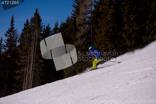 Image of Skier having fun while running downhill