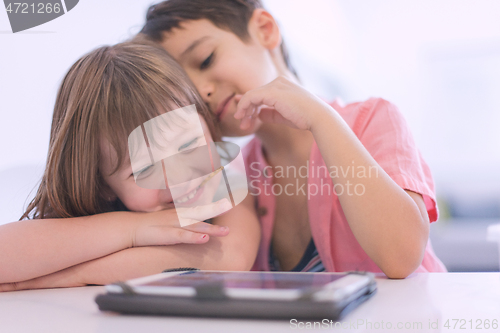 Image of cute little brother and sister having fun at home