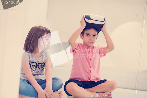 Image of kids using virtual reality headsets at home