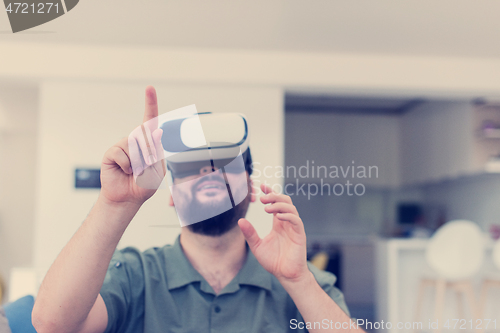 Image of man with beard trying vr glasses