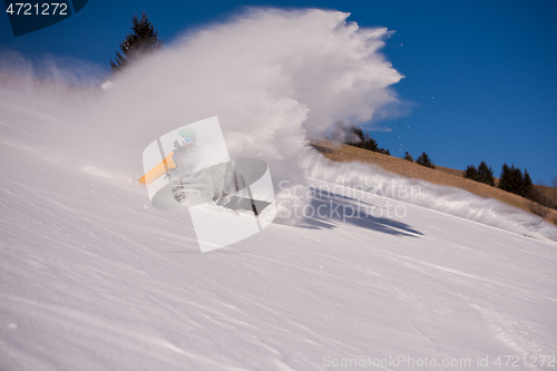 Image of snowboarder crashes while carving down