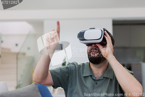 Image of man with beard trying vr glasses