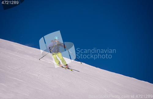 Image of Skier having fun while running downhill