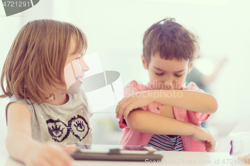 Image of cute little brother and sister having fun at home