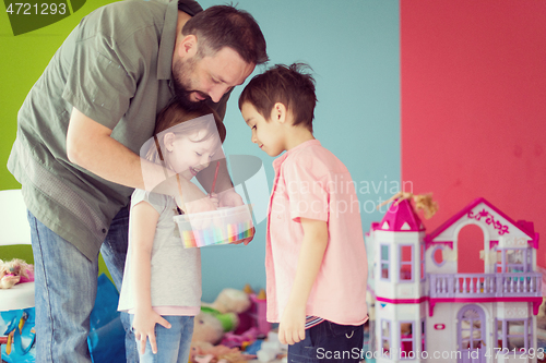 Image of sister and brother havin fun and play hairstylist game at home