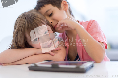 Image of cute little brother and sister having fun at home