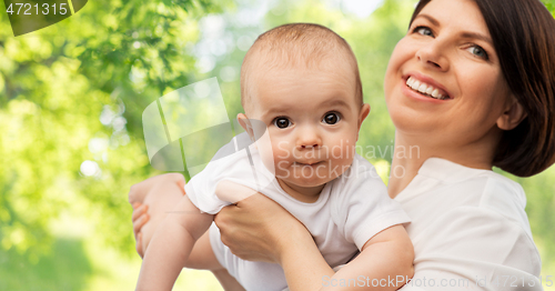 Image of happy middle-aged mother with little baby daughter