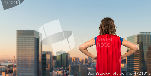 Image of woman in red superhero cape over tokyo city