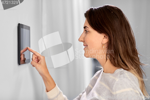 Image of woman using tablet computer at smart home