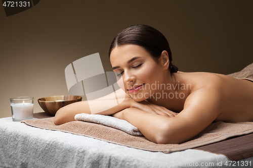 Image of young woman lying at spa or massage parlor