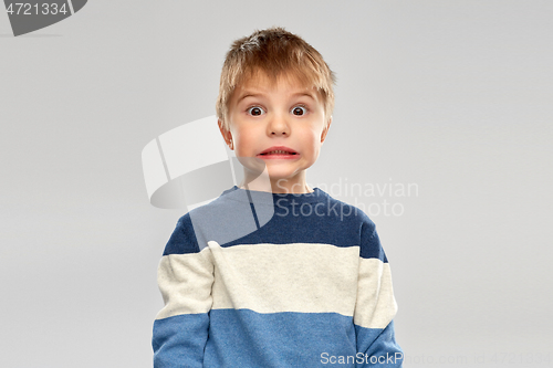 Image of shocked little boy in striped pullover