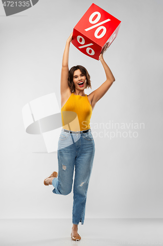 Image of happy smiling young woman with sale sign